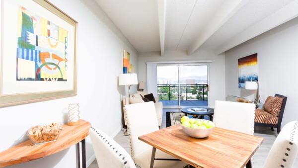 Living area with wood floor, dining table with chairs, and living room with comfortable furniture.