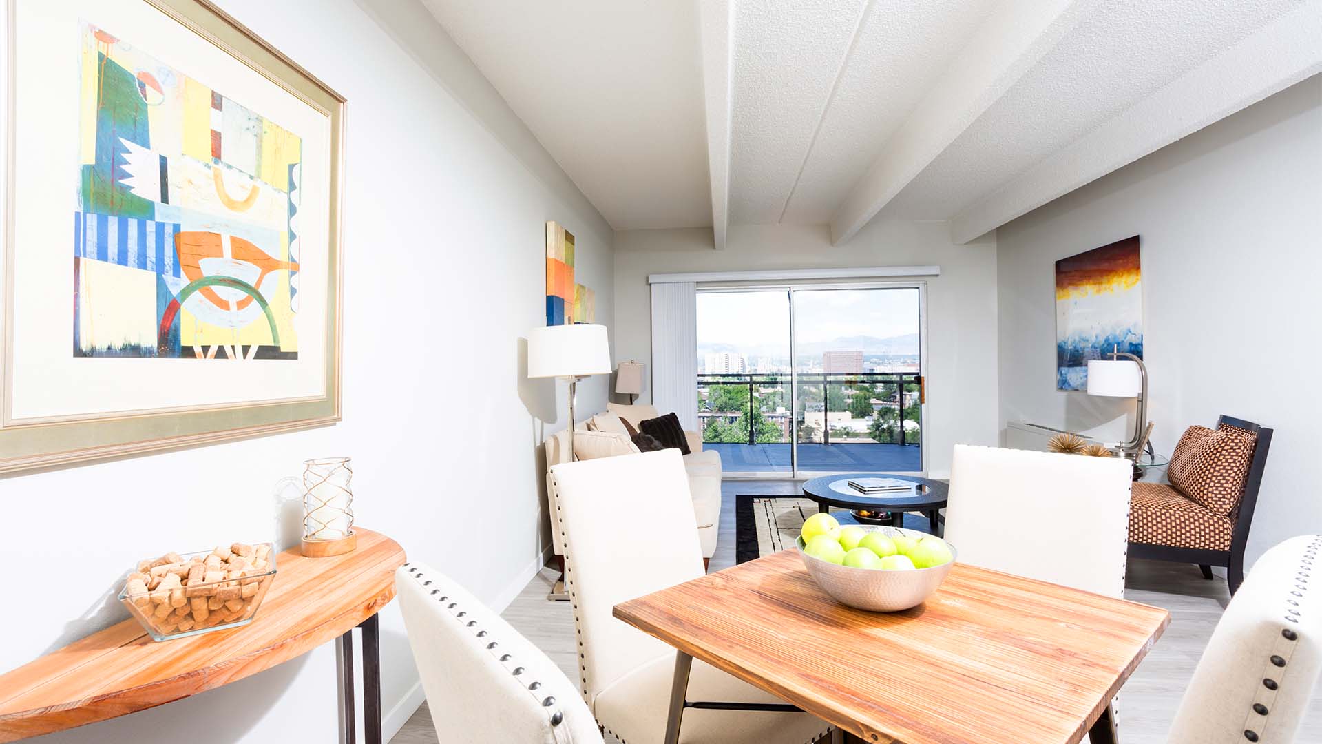 Living area with wood floor, dining table with chairs, and living room with comfortable furniture.