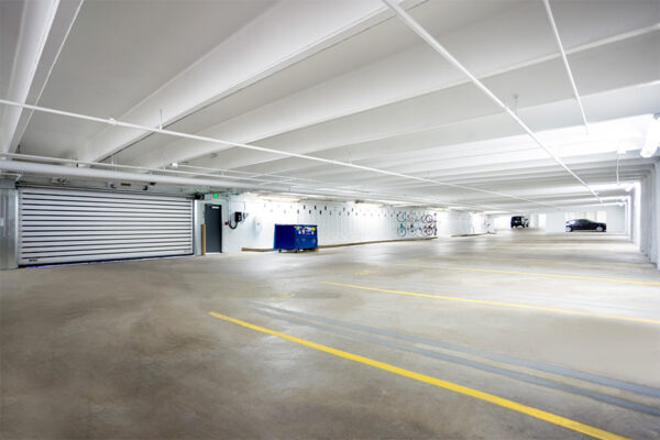 1044 Downing garage with smooth concrete floors and entry door.