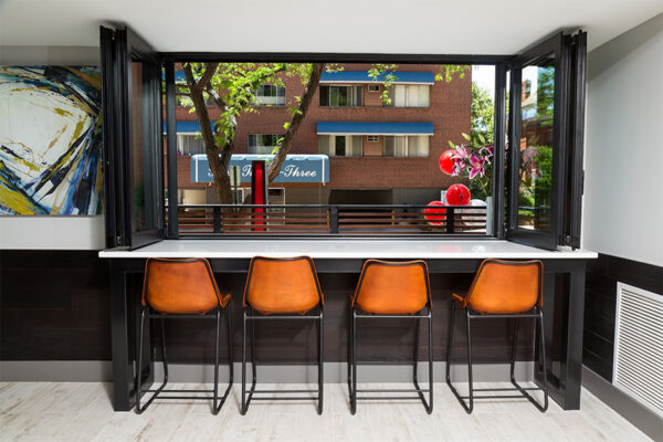 Bartop with open window looking out into street.