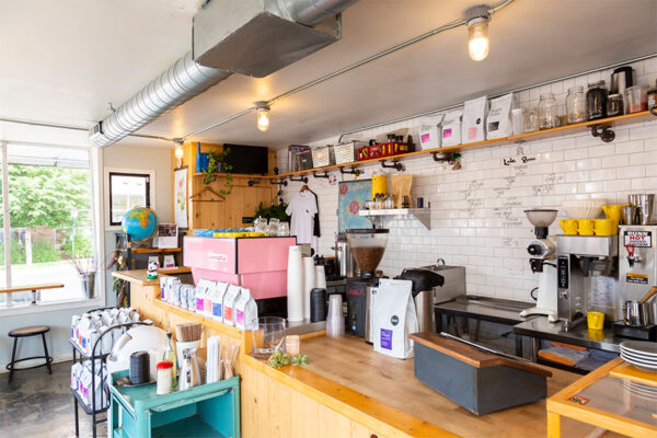 Coffee shop interior with subway tiled walls and coffee making tools.