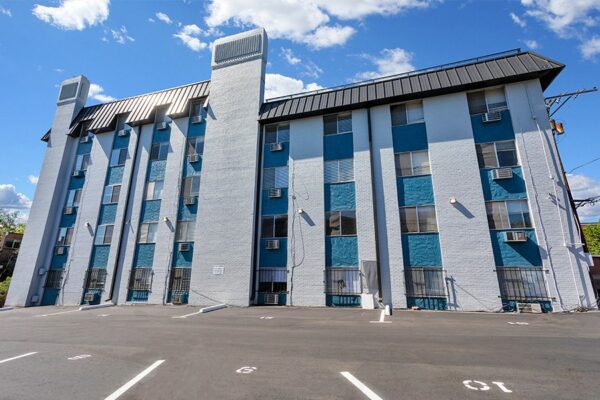 10 South Penn apartments with classic grey brick construction and ample parking.