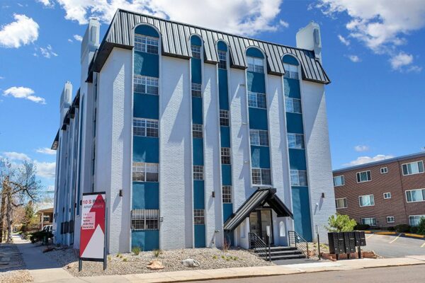 10 South Penn apartments with classic grey brick construction, ample parking, and mailboxes.