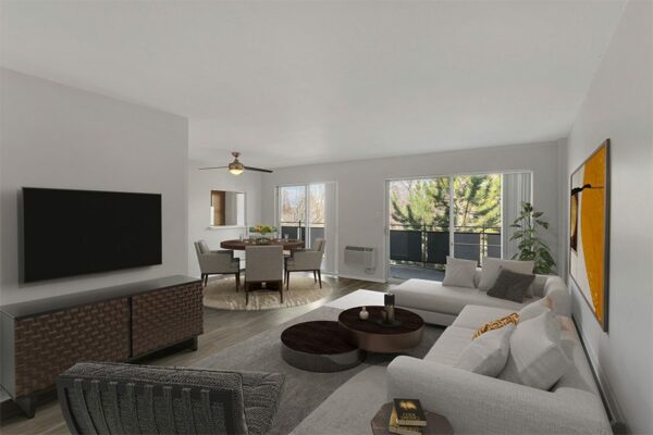 Living room with plush section, modern furniture, and large balcony doors.