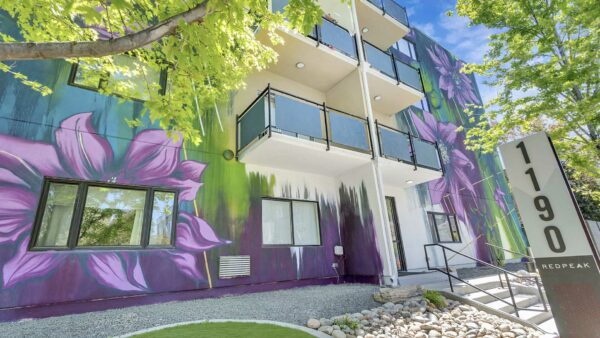 1190 Birch apartments with colorful floral mural.