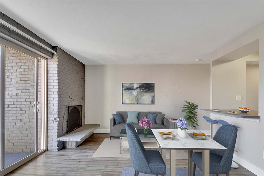 1265 Downing apartment dining and living area with a brick fireplace.