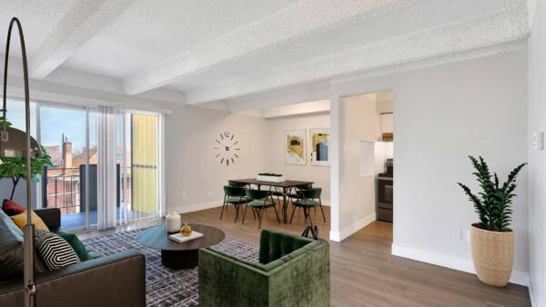 Living area with modern living room, comfortable dining room with clock, and door to balcony.