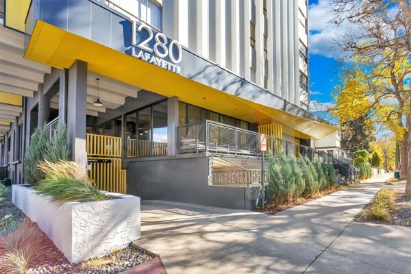 1280 Lafayette apartment entrance with lush landscaping and modern architecture.