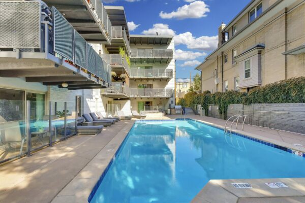950 Lafayette pool area with lounge chairs overlooked by apartment balconies.