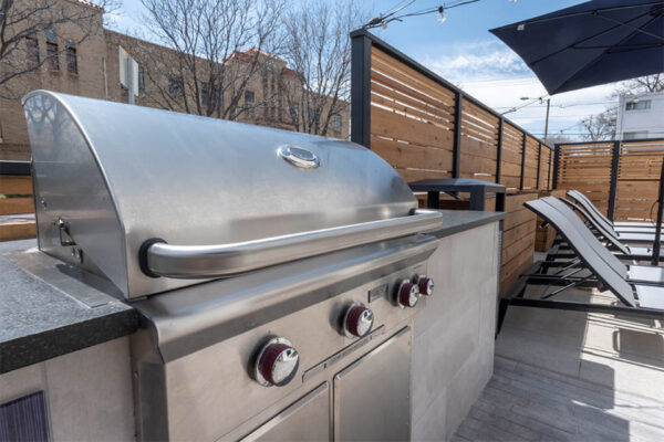 Detail of outdoor BBQ grill on patio space.