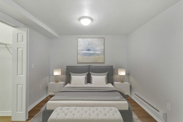 1357 & 1373 Cook bedroom with plush bed and framed artwork.
