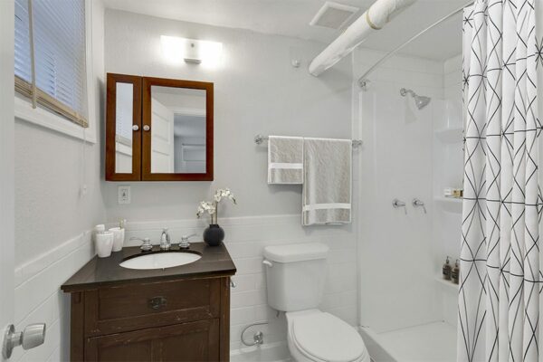 1357 & 1373 Cook bathroom with wood cabinets and tiled shower tub.