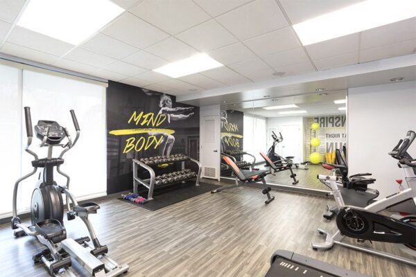 Fitness center with cardio machines and weight equipment.