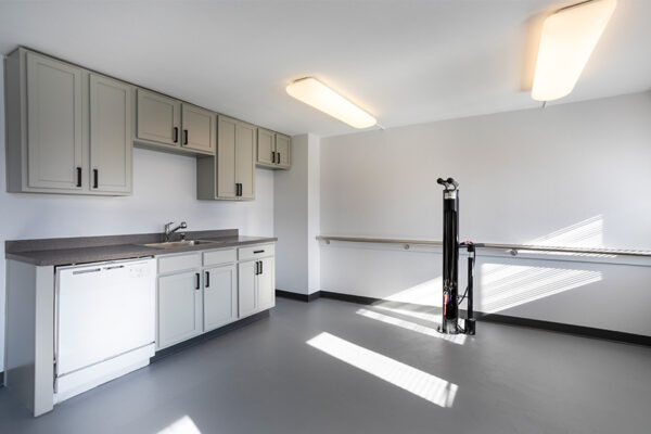 Bike room with repair stand and cabinets.