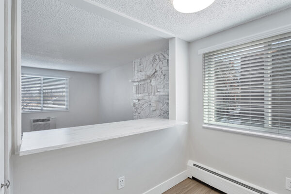 Kitchen breakfast bar with opening to living room.
