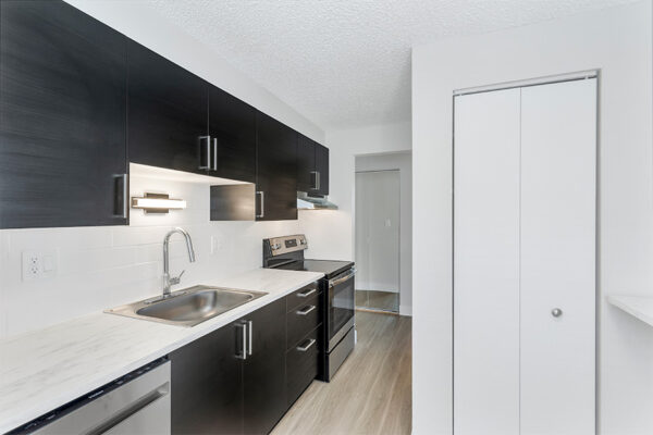 Kitchen wood cabinets, light floors, stainless steel appliances, and pantry.