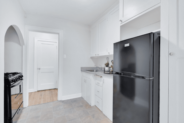 kitchen with refrigerator and oven with counter space and sink in background