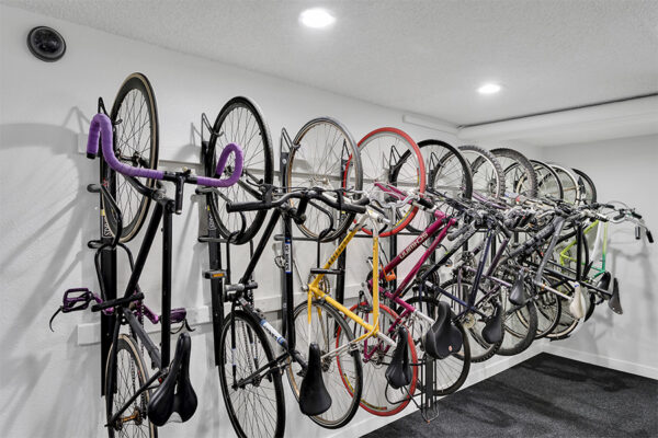Bike storage room with bike hanging rack.