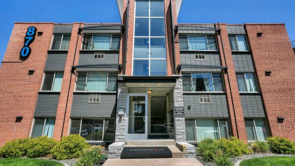 870 Cherry building with glass entrance doors and lush landscaping.