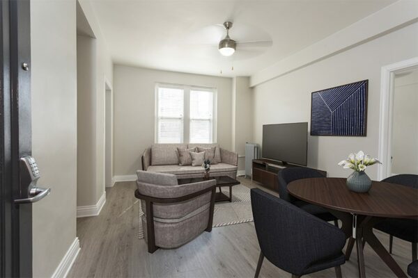Living room with plush seating, modern furniture, and large TV.