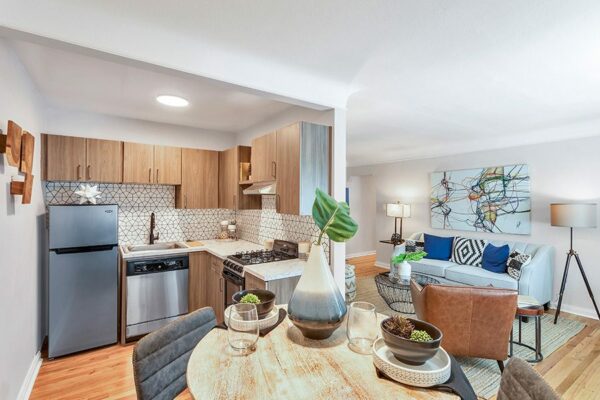 View of kitchen from dining table and living room with new appliances