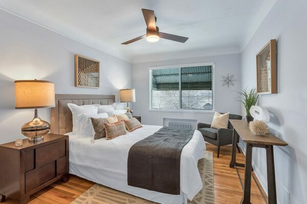 bedroom with window and ceiling fan, clean decor