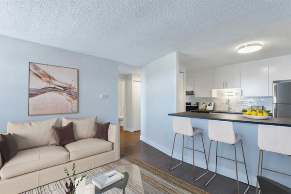 Apartment living room with modern furniture and breakfast bar with opening to kitchen.