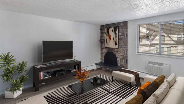 Apartment living room with modern furniture, large TV, and fireplace.