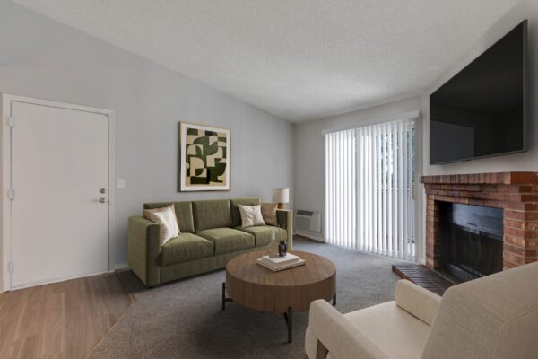 living room with fire place, couches, coffee table and sliding door to balcony