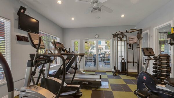 Fitness center with treadmills and a Smith machine.