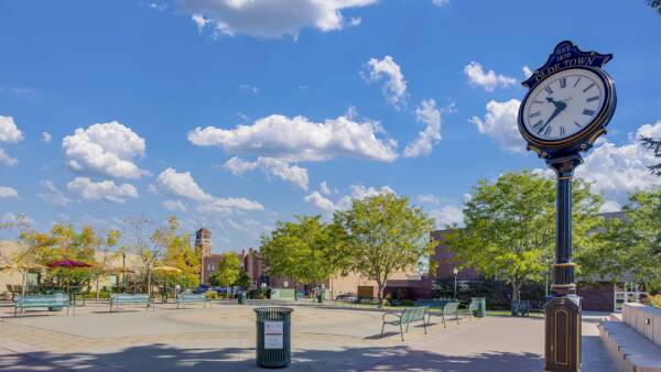 Olde Town Arvada with public square, benches, trees, and clock.
