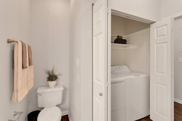 Bathroom with toilet and washer/dryer.