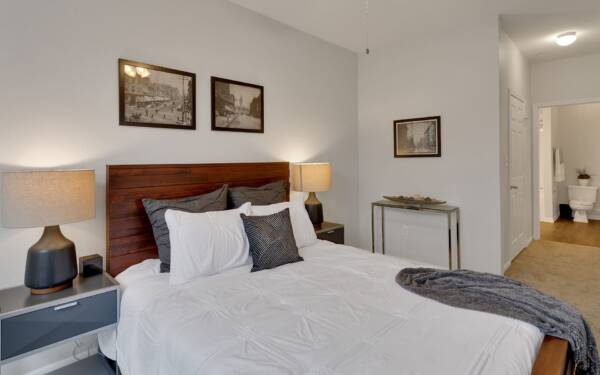 Bedroom with queen size bed and dresser.