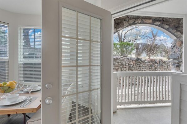Apartment patio overlooking the outdoors.