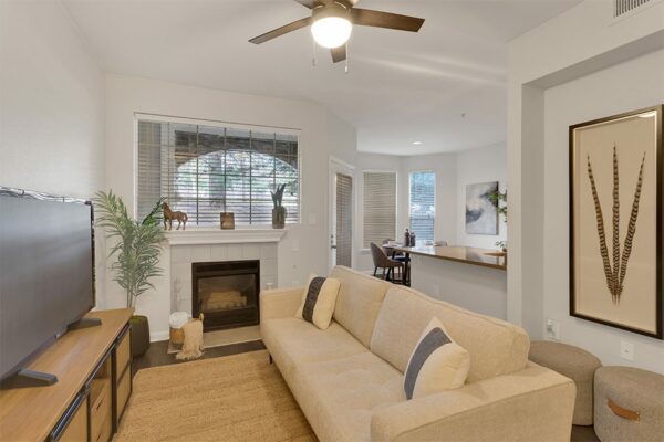 Living room with couch and fireplace.