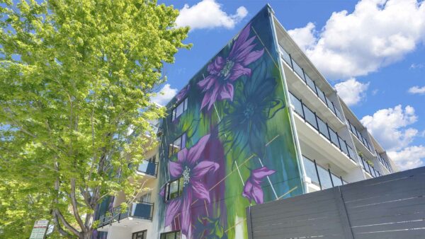 Large flower mural on side of 1190 Birch apartments.