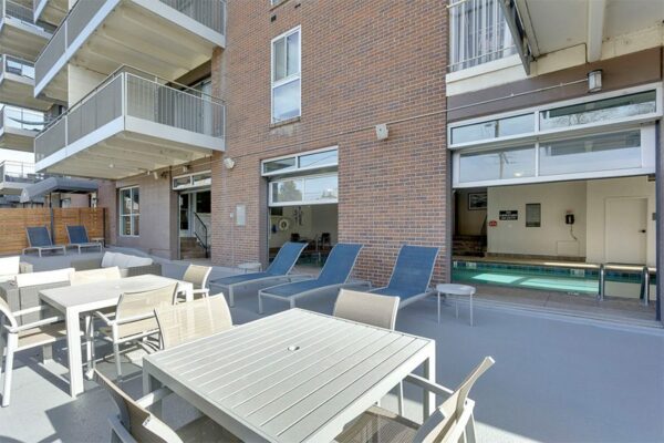 Outdoor seating areas at 515 Clarkson with lounge chairs and a table with chairs.