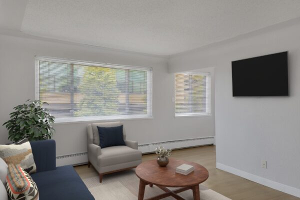 studio apartment with twin bed and couch on the left and kitchen on the right