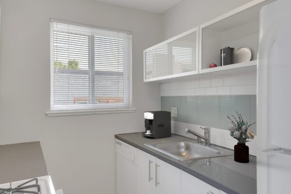 kitchen with white cabinets and fridge, stainless Steel appliances, and window