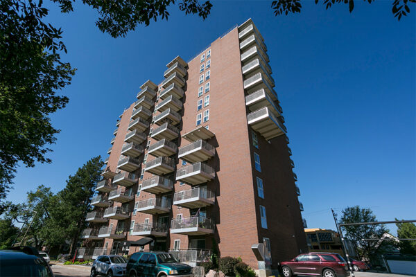 515 Clarkson apartments exterior with brick construction and large balconies.