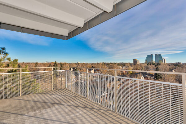 Balcony with metal railing overlooking Denver.