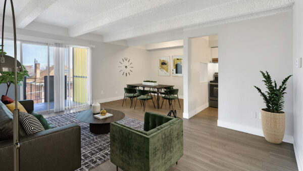 Living area with wood floors, modern furniture, dining table with chairs, and door to balcony.