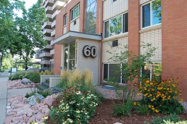 60 Corona apartments with classic brick construction and lush landscaping.