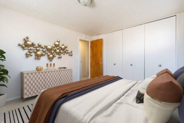bedroom with king size bed, dresser, and doorway view