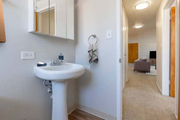 bathroom with sink and doorway to living room