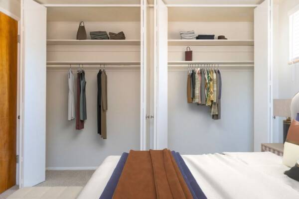 bedroom with closet view with clothing hanging