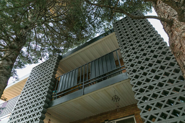 Upward view towards 70 Clarkson apartment balconies with classic decorative cinderblock construction.