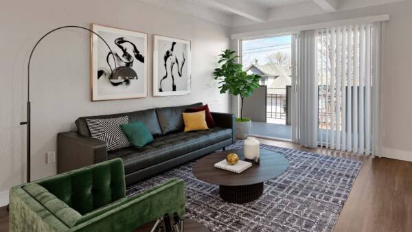 Living room with rug, comfortable modern furniture, floor standing lamp, artwork, and sliding door to balcony.
