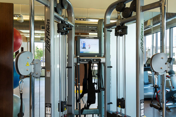 Detail of weight lifting machine in fitness center.