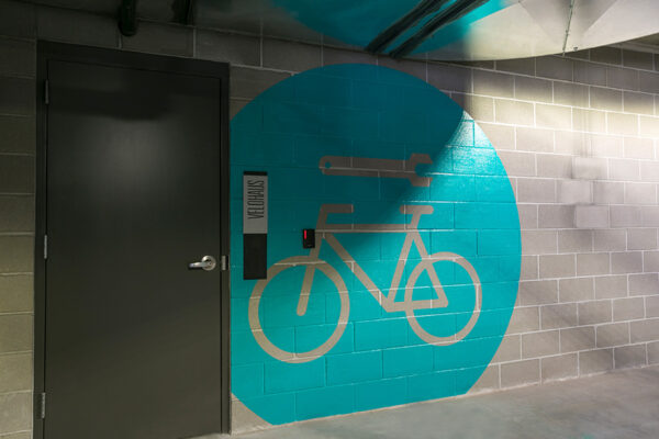 Entrance to bike repair room with large painted wall graphic.
